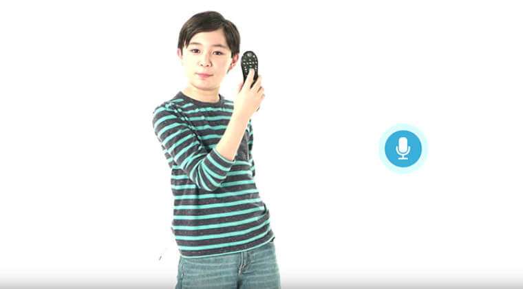 young boy holding a remote