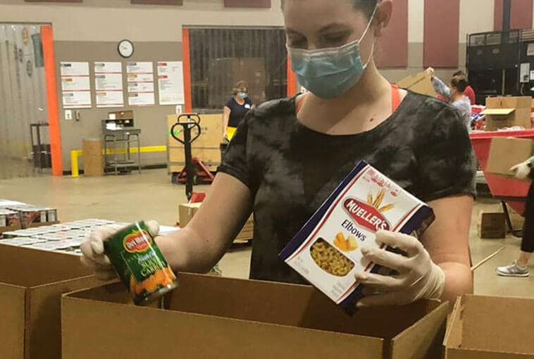 woman putting food into boxes