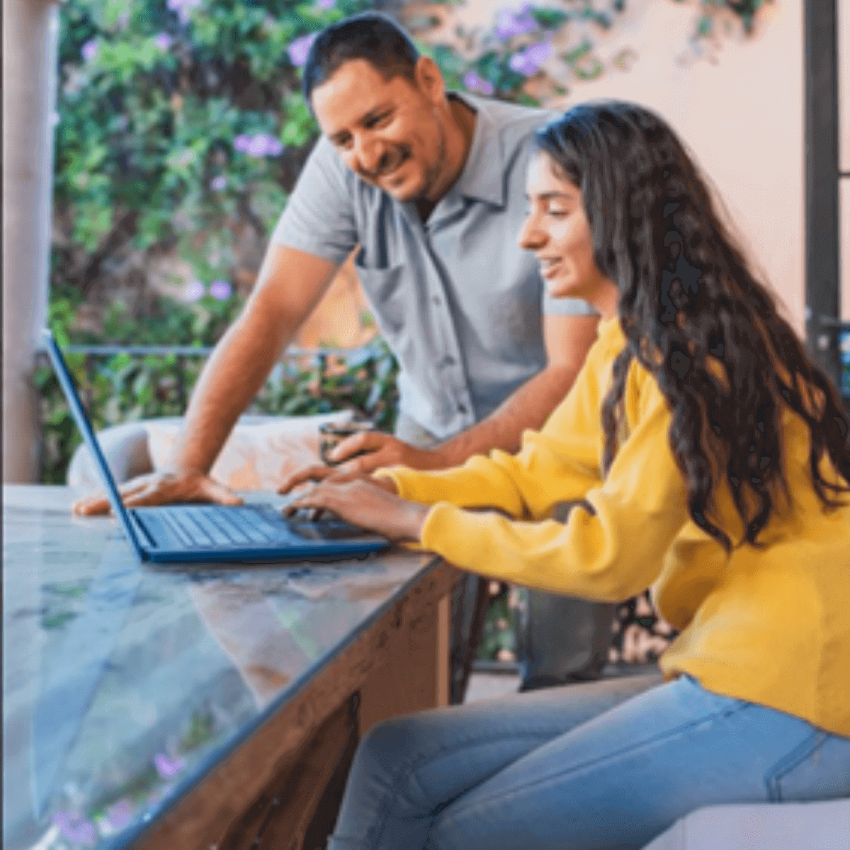 father and daughter looking at their laptop