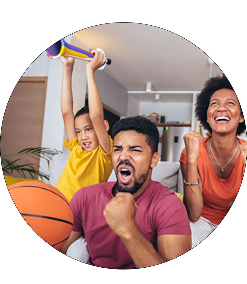 a family celebrating their basketball team in their living room