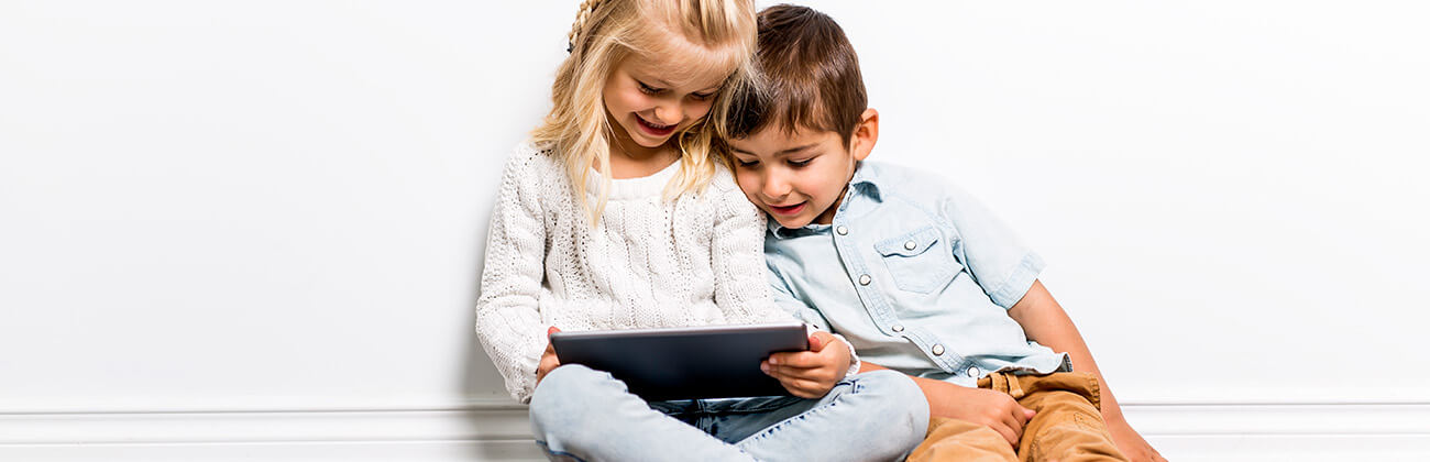 Young siblings looking at a tablet