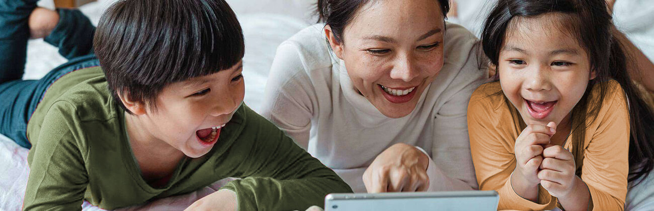 mother and children watching something on their tablet