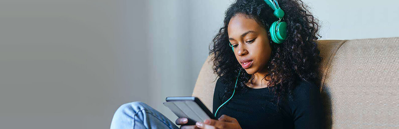 Girl on tablet with headphones