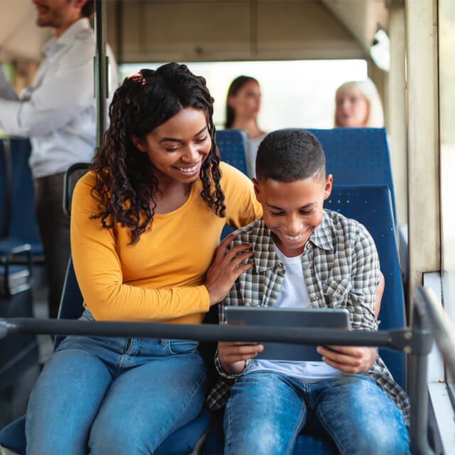 Mom and son look at tablet together during Black History Month